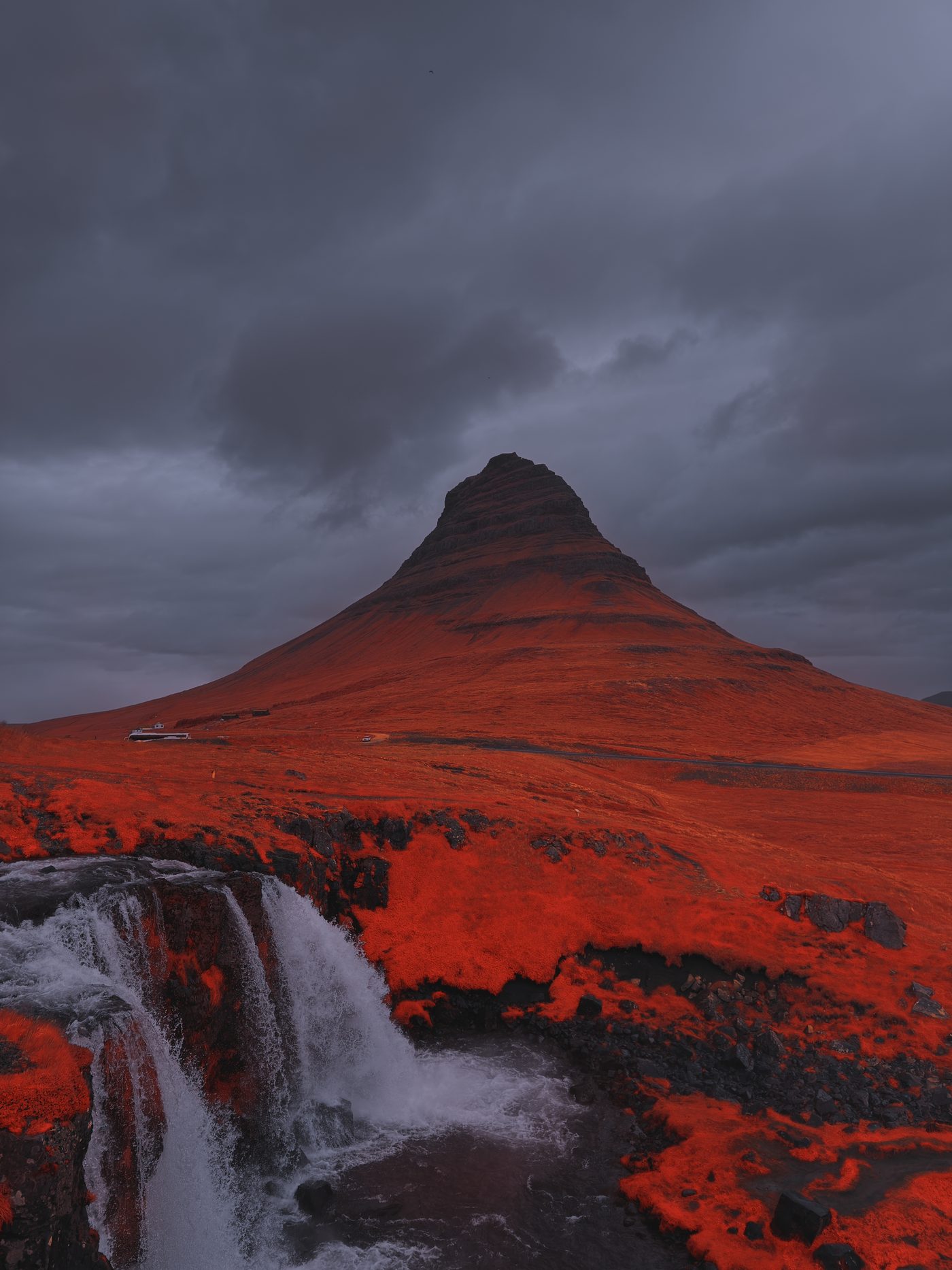 Kirkjufell rendered in Aerochrome infrared — the mountain all red under a grey sky